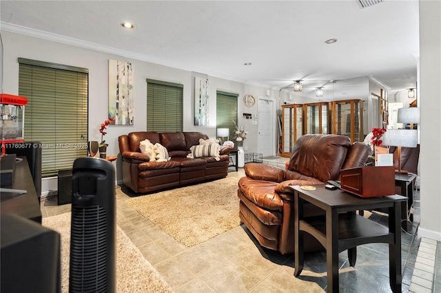 living room featuring crown molding, recessed lighting, baseboards, and tile patterned floors