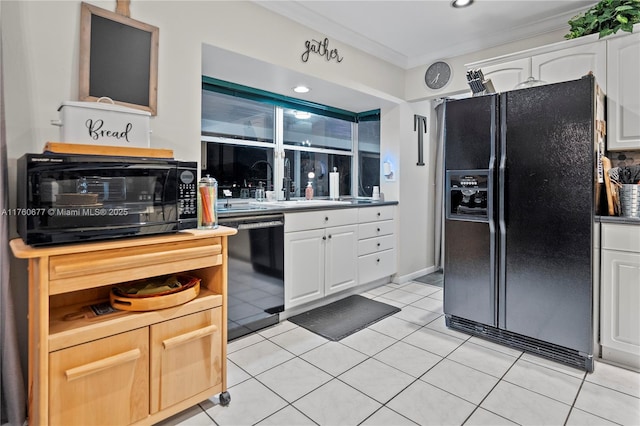 kitchen with white cabinetry, black appliances, light tile patterned floors, and crown molding