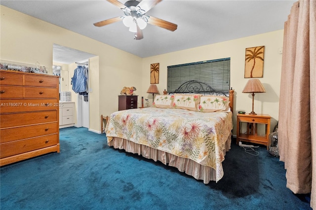 carpeted bedroom featuring a walk in closet, a closet, and ceiling fan