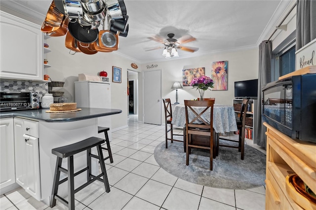 18200 SW 86th Ave, Palmetto Bay, FL 33157 - dining space featuring ornamental molding, light tile patterned floors, and ceiling fan