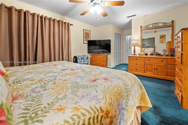 bedroom with visible vents, a closet, ceiling fan, and dark carpet