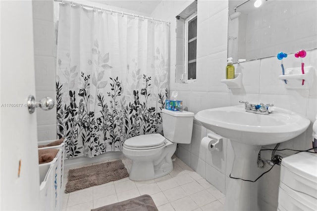 full bathroom featuring curtained shower, toilet, tile walls, and tile patterned flooring