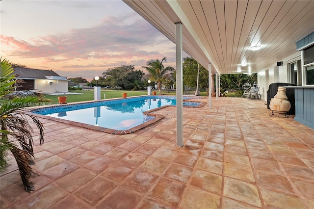 18200 SW 86th Ave, Palmetto Bay, FL 33157 - pool at dusk with a patio area, an outdoor pool, and a lawn