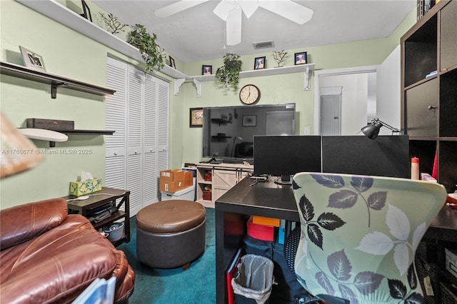 carpeted office featuring visible vents and ceiling fan