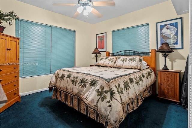 bedroom featuring baseboards, dark colored carpet, and ceiling fan