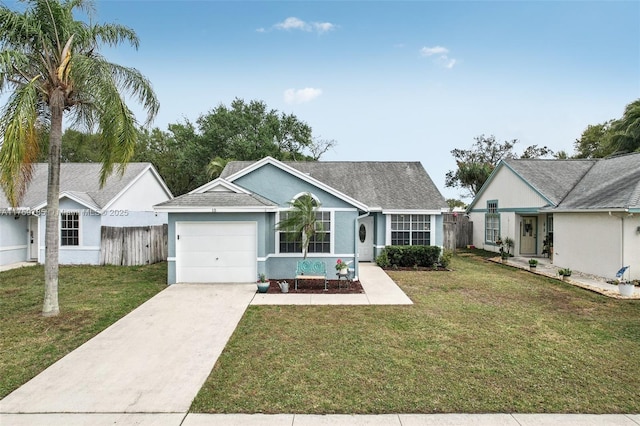 ranch-style home featuring a front yard, an attached garage, driveway, and fence