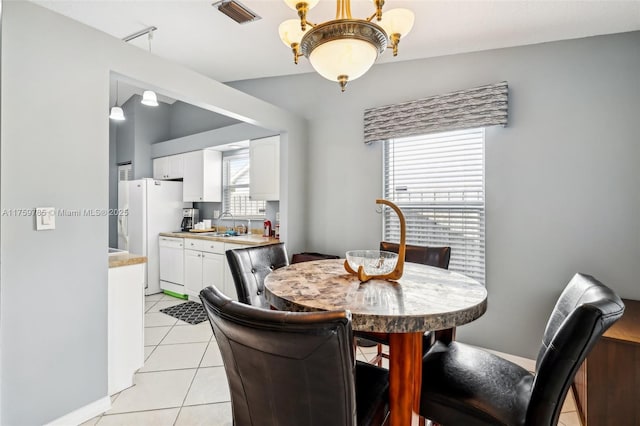 dining area with light tile patterned floors, visible vents, and rail lighting