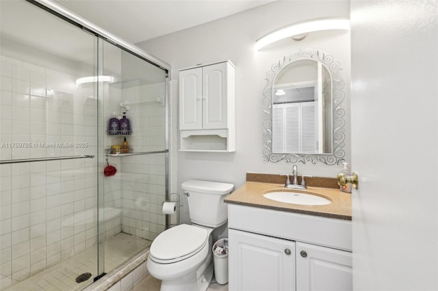 full bathroom with vanity, toilet, and a stall shower