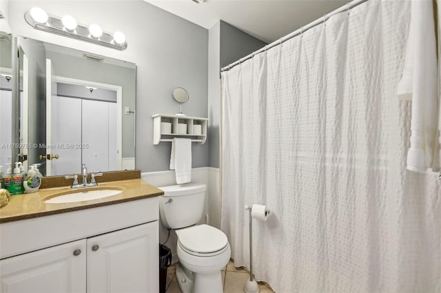 bathroom with vanity, tile patterned floors, and toilet