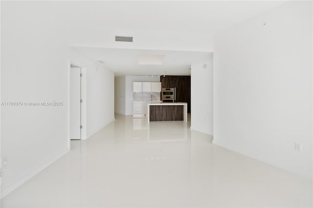 unfurnished room featuring light tile patterned flooring and visible vents