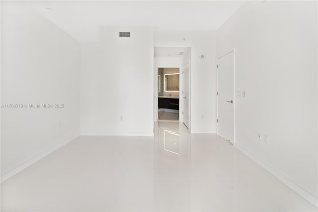 empty room with visible vents and baseboards