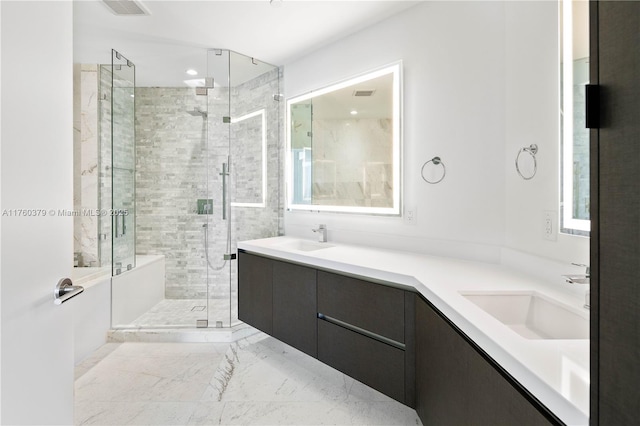 full bathroom with a shower stall, double vanity, visible vents, and a sink