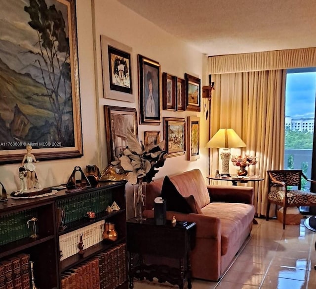 living area with tile patterned floors and a textured ceiling