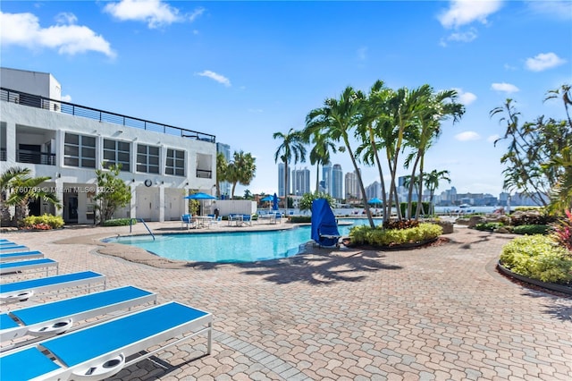 community pool featuring a patio and a view of city