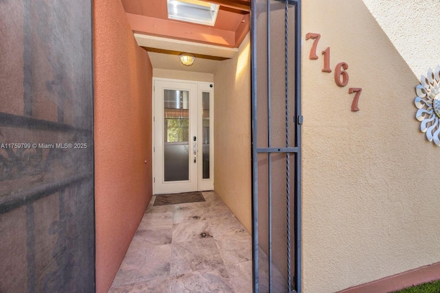 entrance to property featuring stucco siding