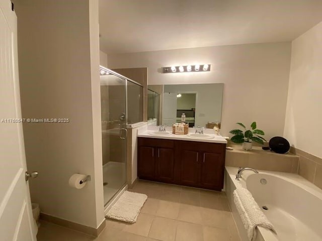 bathroom with a sink, a garden tub, double vanity, and a shower stall