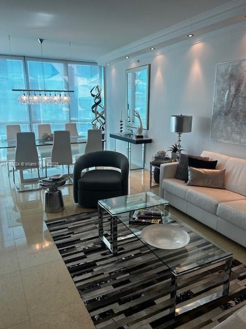 living area featuring recessed lighting, a wall of windows, and ornamental molding