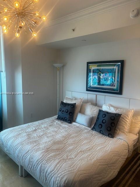 bedroom featuring an inviting chandelier and crown molding