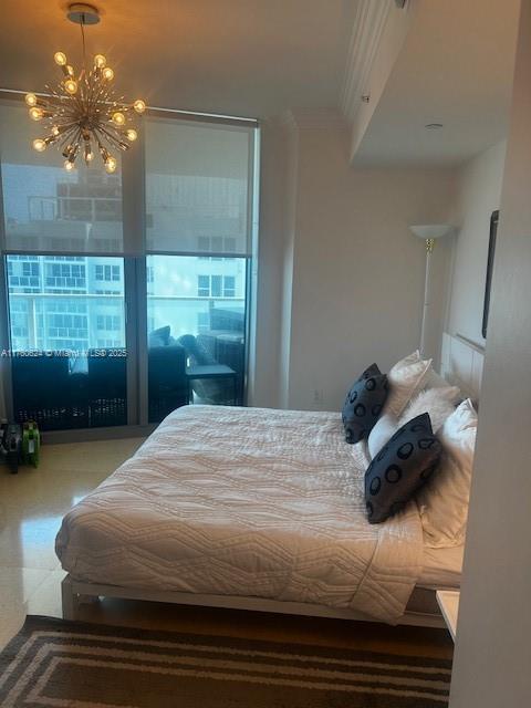 bedroom featuring crown molding and a notable chandelier