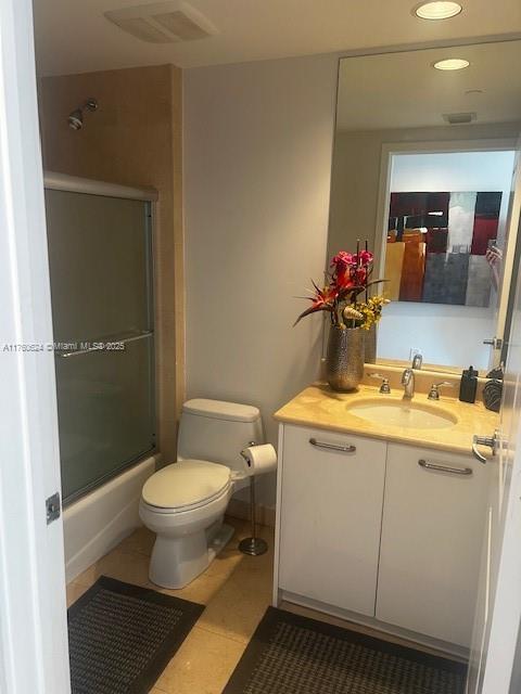 full bathroom featuring tile patterned floors, visible vents, toilet, and vanity