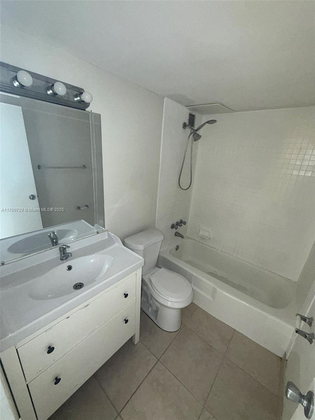 bathroom featuring tile patterned flooring, toilet, vanity, and shower / bathtub combination