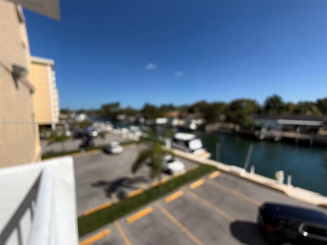 balcony with a water view and a dock