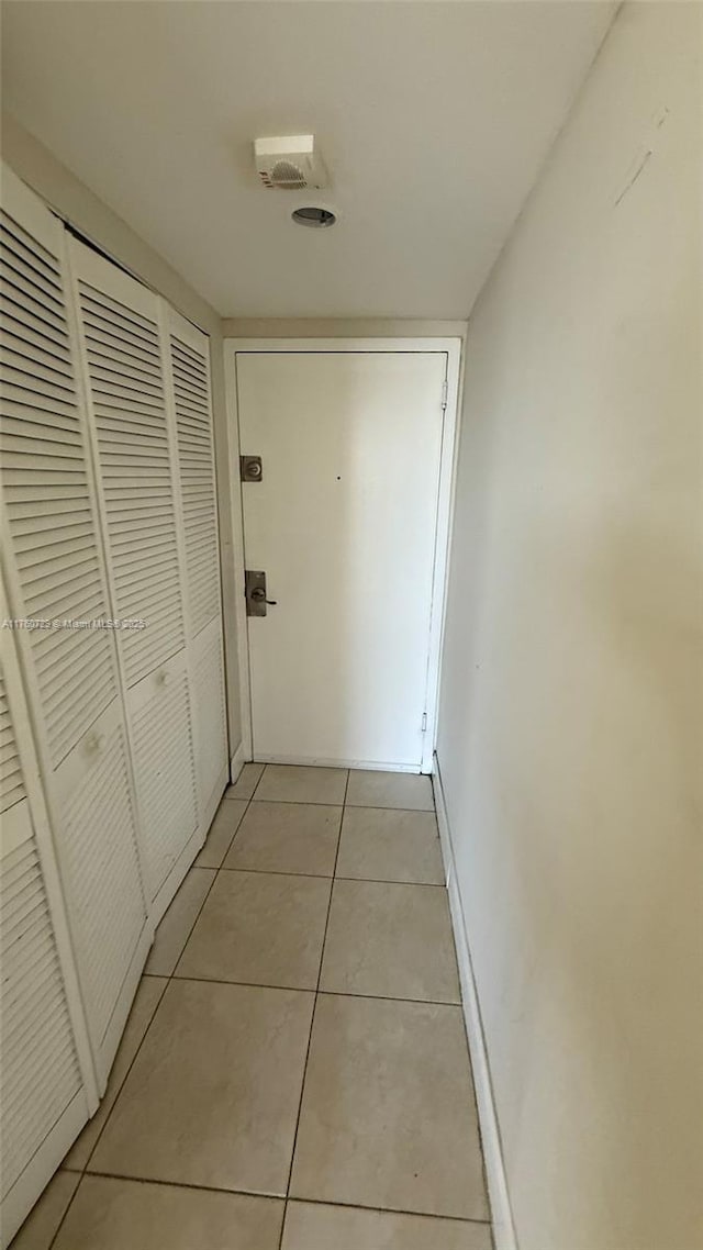 hall featuring light tile patterned flooring