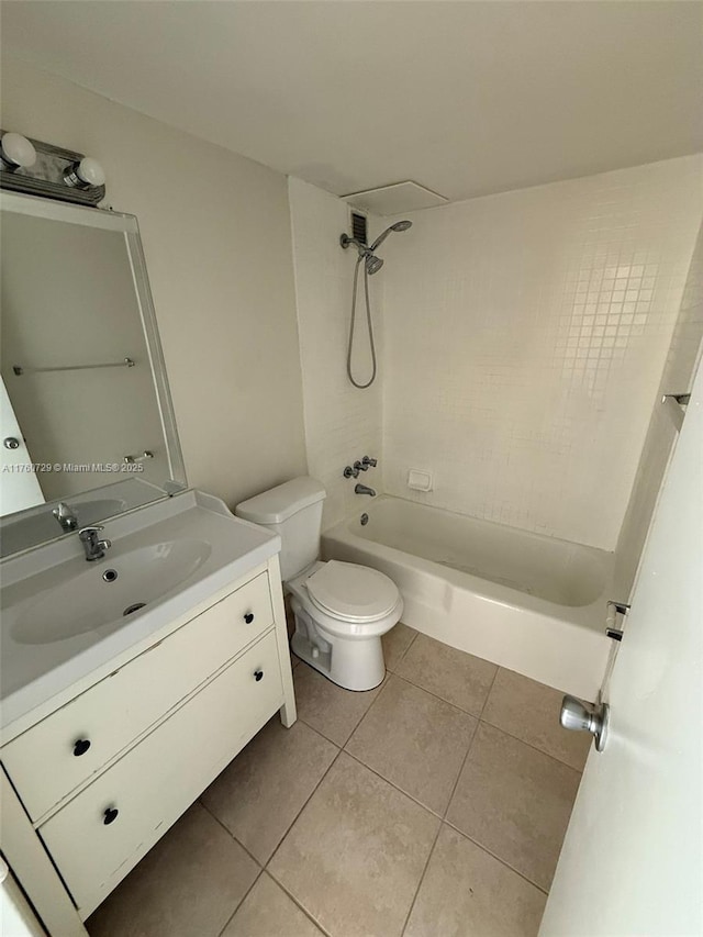 bathroom featuring tile patterned flooring, toilet, vanity, and washtub / shower combination