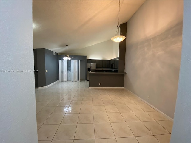 kitchen featuring a ceiling fan, a peninsula, light tile patterned flooring, stainless steel fridge with ice dispenser, and hanging light fixtures