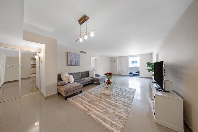 living room with light tile patterned flooring and visible vents