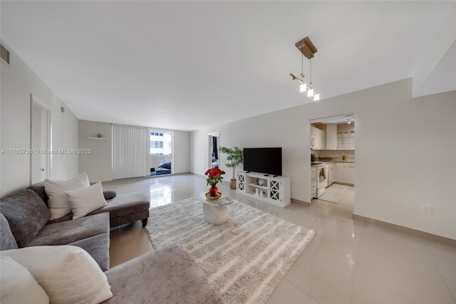 living room featuring light tile patterned floors and visible vents