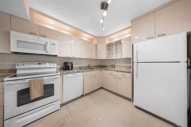 kitchen featuring white appliances, light tile patterned flooring, recessed lighting, and a sink