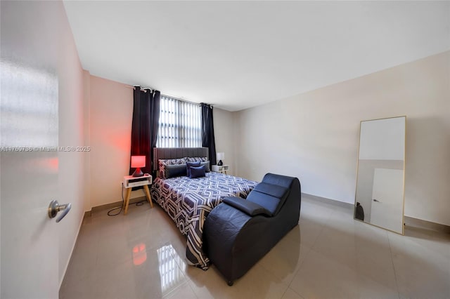 bedroom featuring baseboards and light tile patterned flooring