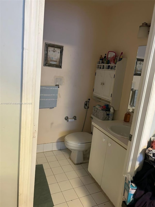 bathroom with tile patterned floors, toilet, and vanity