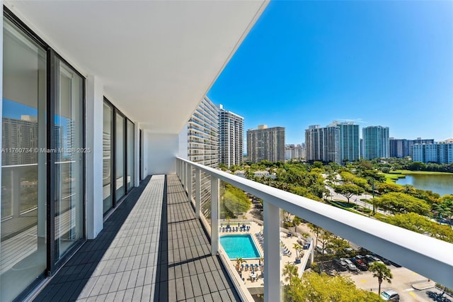 balcony featuring a city view and a water view