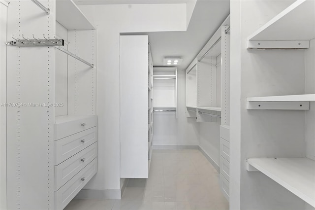 spacious closet with light tile patterned floors