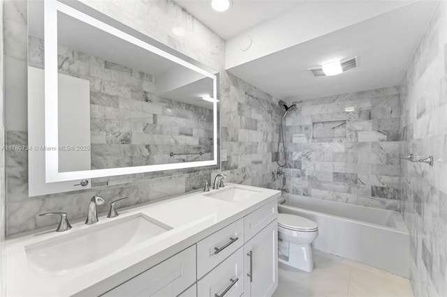 full bathroom with a sink, visible vents, toilet, and tile walls