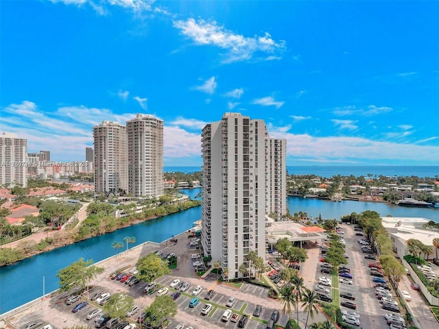 birds eye view of property with a water view and a city view