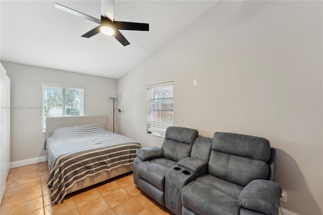 bedroom with light tile patterned floors, baseboards, lofted ceiling, and a ceiling fan