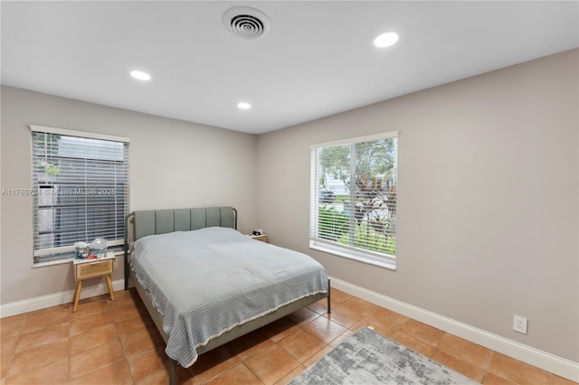 bedroom with light tile patterned floors, visible vents, recessed lighting, and baseboards