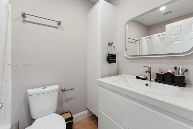 bathroom featuring visible vents, baseboards, toilet, tile patterned floors, and vanity