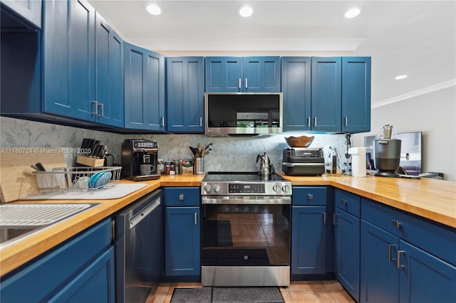 kitchen featuring blue cabinets, appliances with stainless steel finishes, butcher block counters, and crown molding