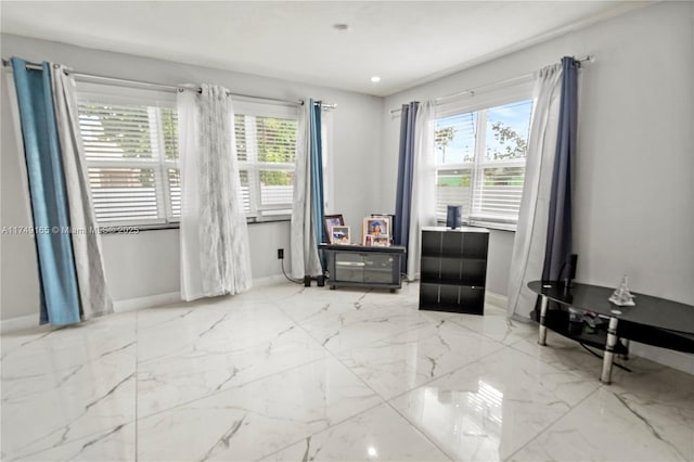 unfurnished room featuring baseboards and marble finish floor