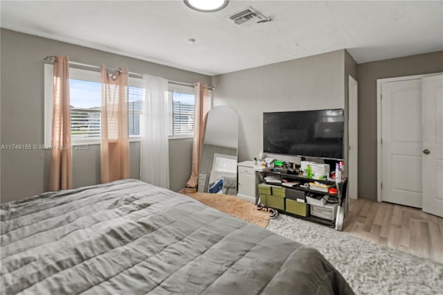 bedroom with visible vents and wood finished floors