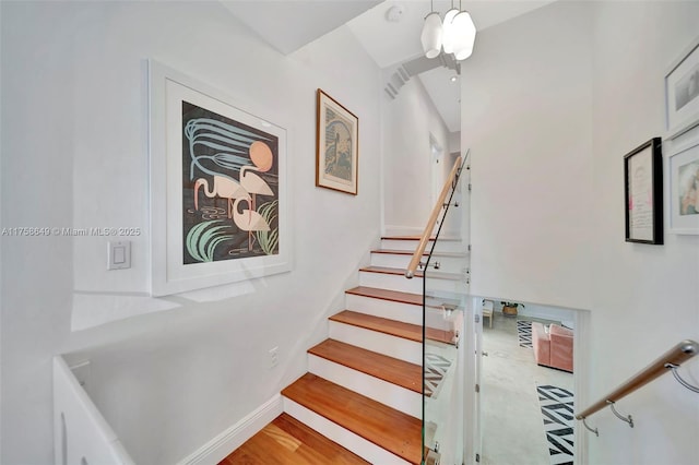 stairs featuring baseboards and wood finished floors