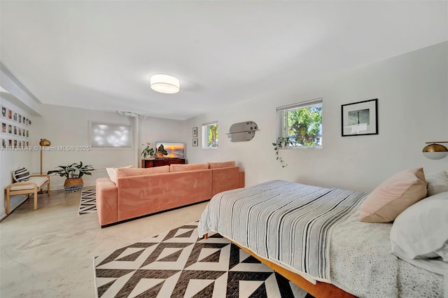 bedroom featuring finished concrete floors