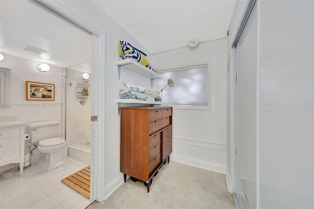 bathroom featuring visible vents, toilet, a stall shower, baseboards, and vanity