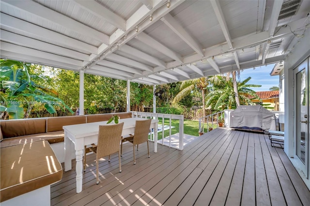 wooden deck featuring outdoor dining space and visible vents