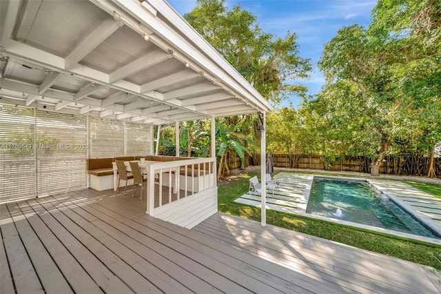 deck featuring a fenced in pool and a fenced backyard