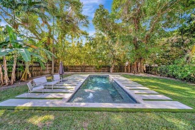 view of pool featuring a yard, a patio, and a fenced backyard